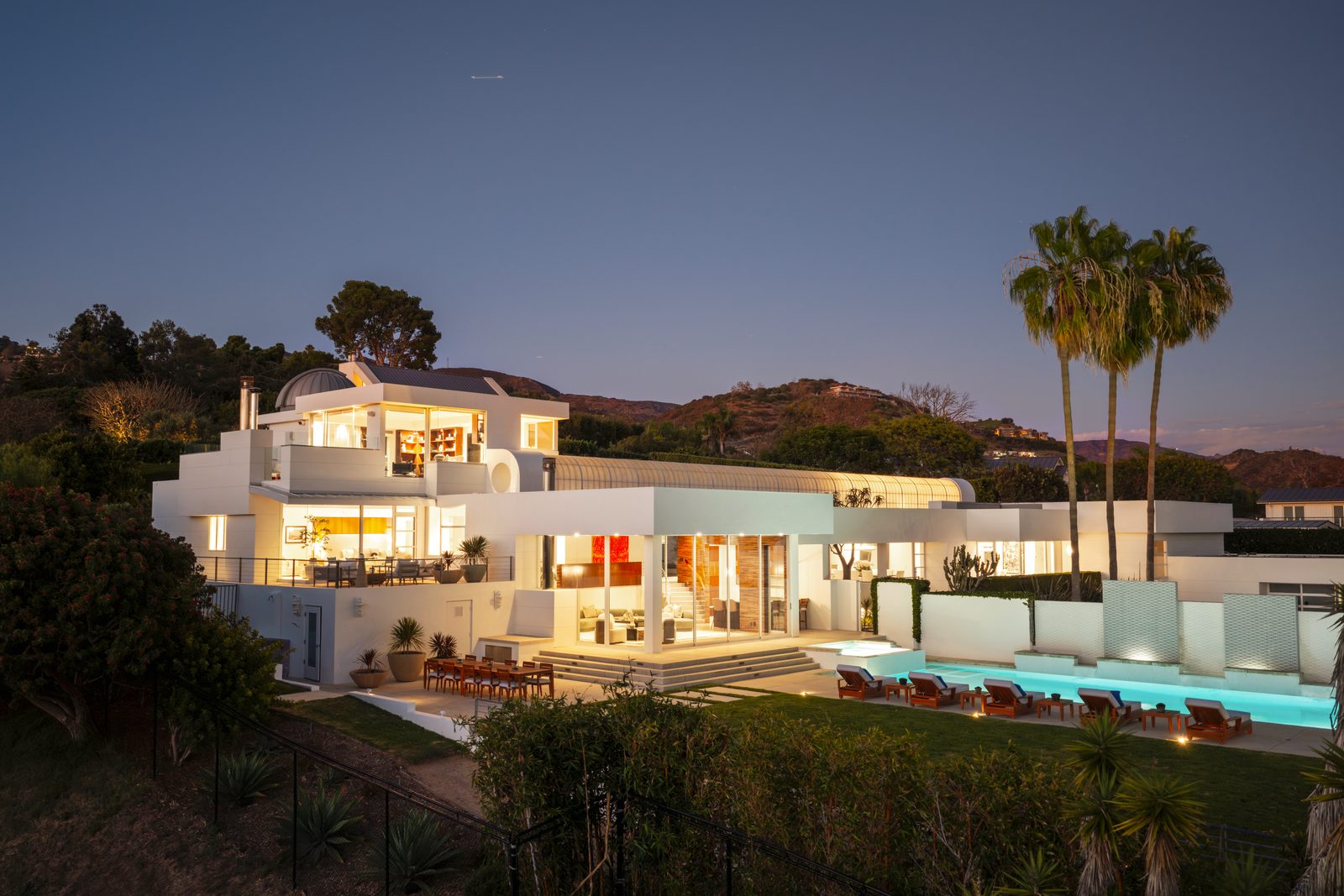 Illuminated residence and swimming pool at twilight